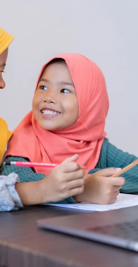 girl with Hijab smiling and learning